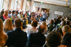 Facilitator addressing crowd around him